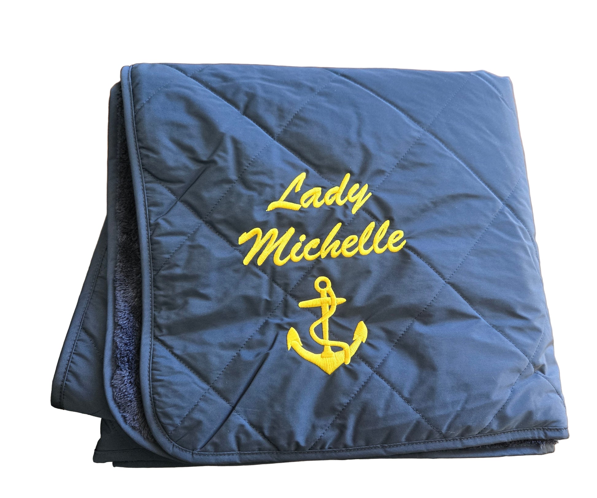 Folded navy blanket with 'Lady Michelle' and anchor emblem 